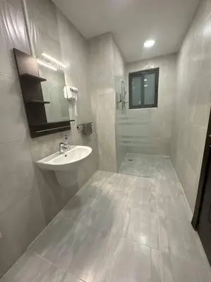 a white bathroom with a sink and a shower at 2 En-suite Rooms, Central & Spacious in Amman