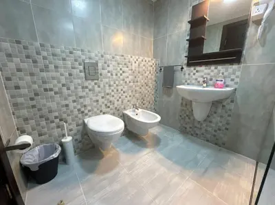 a bathroom with a toilet and a sink at 2 En-suite Rooms, Central & Spacious in Amman