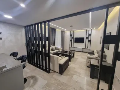 a living room with a couch and a table at Dier Ghbar 2 bedrooms-A in Amman