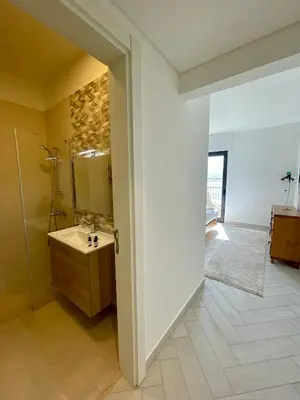 a bathroom with a sink and a shower and a mirror at Aladdin Chalet 13 in Aqaba