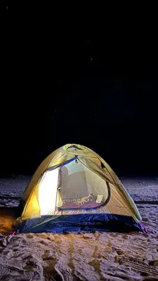 a tent sitting on the ground in the dark at Camp star road safari in Wadi Rum