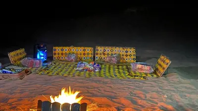 a group of chairs sitting around a fire at Camp star road safari in Wadi Rum