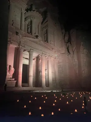 a large building with lights in front of it at night at Indiana Jones Home Stay in Petra