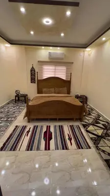 a bedroom with a bed and a large rug at Indiana Jones Home Stay in Petra