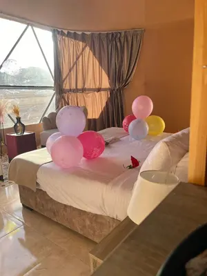 a group of balloons on a bed in a room at Bright Stars Camp in Disah