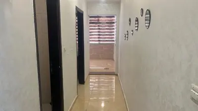 a hallway with a walkway leading to a bathroom at الروف سوبر ديلوكس 2 غرف نوم صالة جلوس و طعام مكيفة للإيجار in Amman
