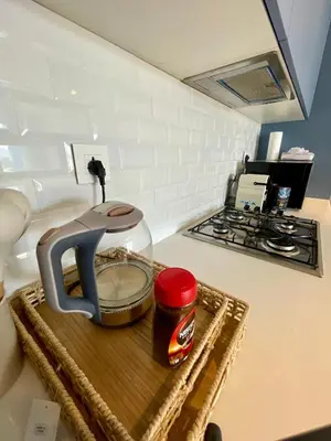 a kitchen counter with a mixer on a cutting board at Aladdin Chalet 15 in Aqaba