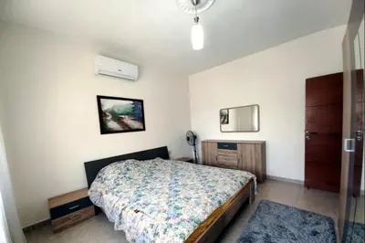 a bedroom with a bed and a telephone in it at Ayyash in Amman