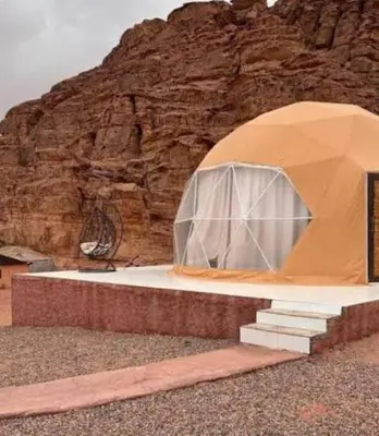 a tent is set up in front of a mountain at RUM MARS lUXURY CAMP in Wadi Rum