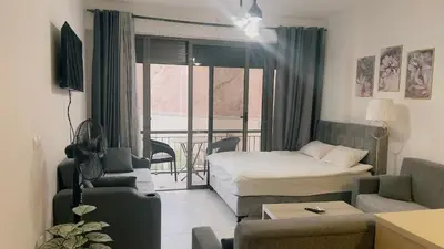a living room with a bed and a couch at Alraha village-aqaba قرية الراحة- مرسى زايد -العقبة in Aqaba