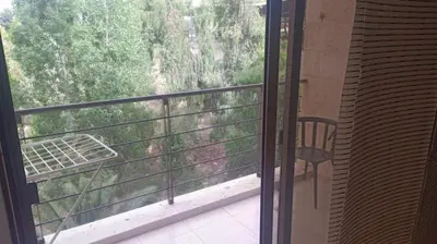 an open door to a balcony with a chair at Elegant Apartment in Amman
