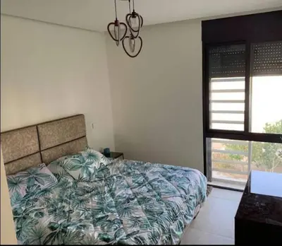 a bedroom with a bed and a window at Modern Apartment In Ayla in Aqaba