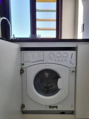 a washing machine in a kitchen with a window at Modern Apartment In Ayla in Aqaba