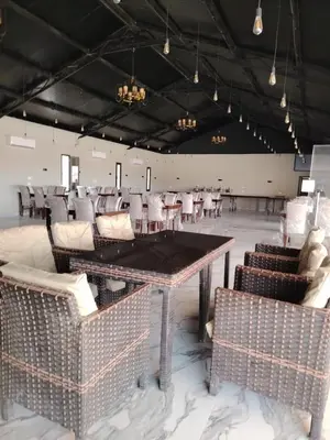 a room with chairs and a table in a room at Eagle Rum Camp in Disah
