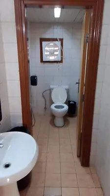 a bathroom with a white toilet and a sink at Mountain star in Disah