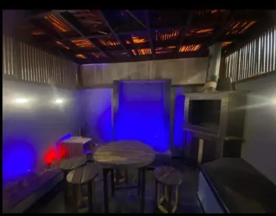 a room with a table and stools and blue lights at الأردن عمان ضاحية الأمير راشد شارع مكه in Umm Uthainah