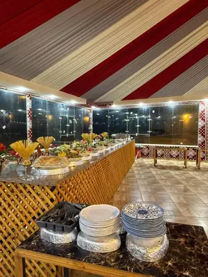 a buffet line with plates and bowls of food at rum luxury camp in Wadi Rum