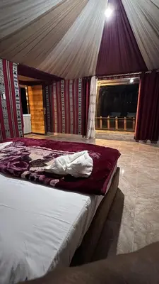 a bedroom with a bed in a tent at Rum Moon Camp in Wadi Rum