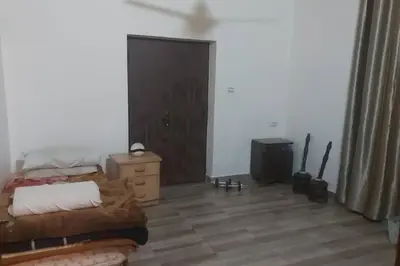 a bedroom with a bed and a wooden floor at Peppermint AL Weibdeh 1-Bed Cozy Apartment in Ash Shumaysānī
