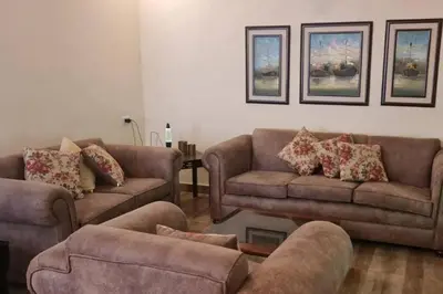 a living room with two couches and a table at Peppermint AL Weibdeh 1-Bed Cozy Apartment in Ash Shumaysānī
