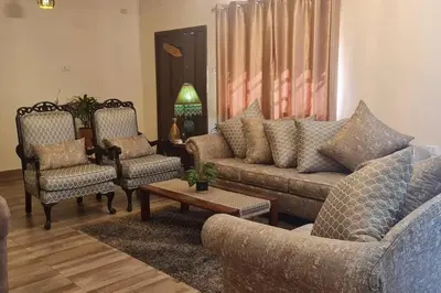 a living room with a couch and two chairs at Peppermint AL Weibdeh 1-Bed Cozy Apartment in Ash Shumaysānī
