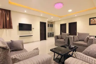 a living room with couches and a flat screen tv at شقه سياحيه أبو نصير in Ţāb Kirā‘