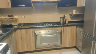 a kitchen with a stainless steel stove top oven at Villa rose 3 in Khirbat Abū Ḩāmid