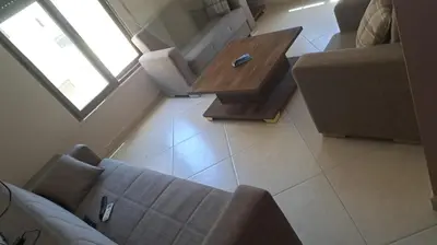a living room with a couch and a coffee table at أبو راشد للشقق المفروشه in Aqaba