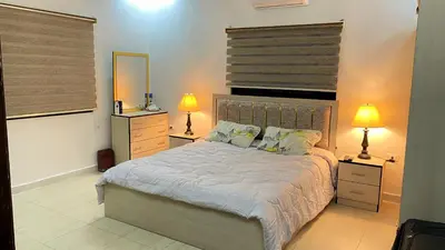 a bedroom with a bed with two lamps and a mirror at Jerash Gate in Jerash