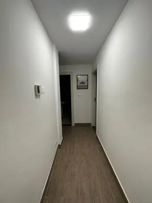 an empty hallway with white walls and a wooden floor at central apartment for rent 17 in Amman