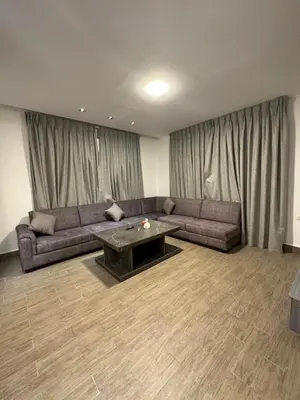 a living room with a couch and a table at central apartment for rent 17 in Amman