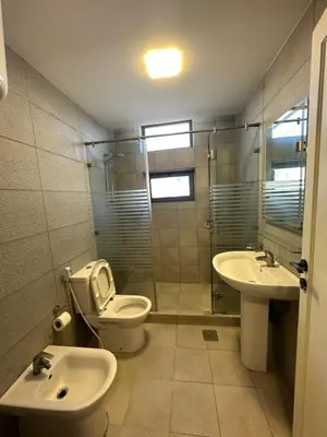 a bathroom with a toilet and a sink at central apartment for rent 18 in Umm Uthainah