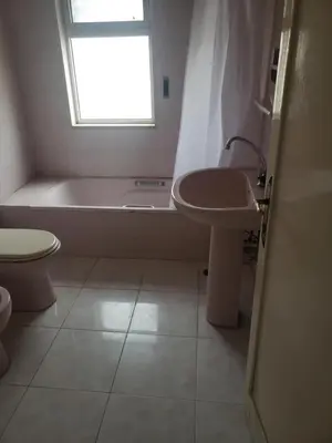a bathroom with a tub and a sink and a toilet at Alotaibi #6 in Amman