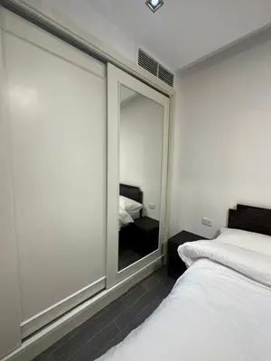 a bedroom with a large glass window with a bed at central apartment for rent 20 in Amman