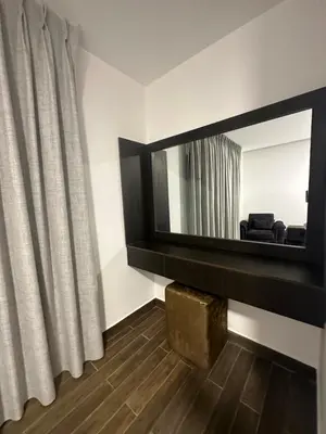 a living room with a mirror and a curtain at central apartment for rent 20 in Amman