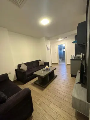 a living room with a couch and a coffee table at central apartment for rent 21 in Amman