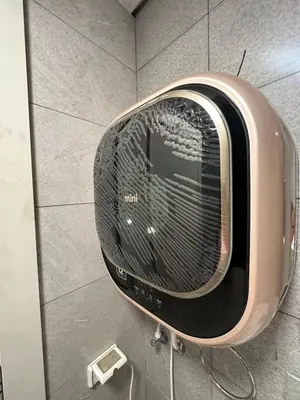 a toaster oven on the wall of a bathroom at central apartment for rent 23 in Umm Uthainah