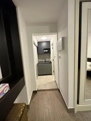 a hallway leading to a room with a kitchen at central apartment for rent 23 in Umm Uthainah