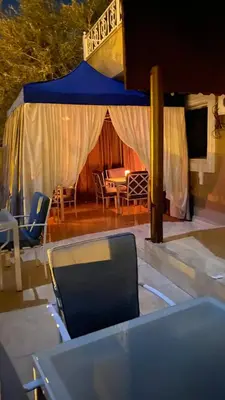 a table and chairs under a tent with a table at Eighth Wonders Hotel in Wadi Musa