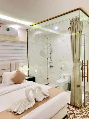 a bedroom with a bed and a shower and a toilet at Eighth Wonders Hotel in Wadi Musa