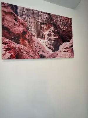 a painting of a building in a canyon on a wall at 9 Antica jabalal-lwebdeh in Amman