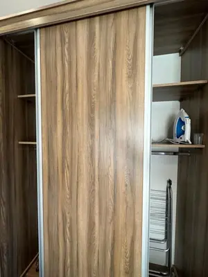 a closet with wood paneled walls and shelves at 9 Antica jabalal-lwebdeh in Amman
