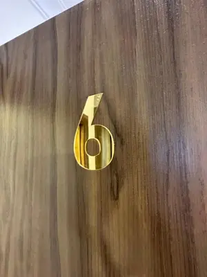 a gold number five on a wooden wall at 10 Antica jabalal-lwebdeh in Amman