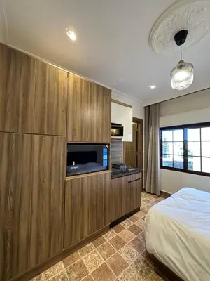 a bedroom with a bed and a flat screen tv at 11 Antica jabalal-lwebdeh in Amman