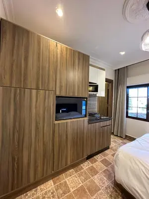 a bedroom with a large wooden cabinet with a tv at 11 Antica jabalal-lwebdeh in Amman
