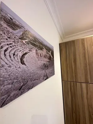 a painting hanging on a wall next to a cabinet at 11 Antica jabalal-lwebdeh in Amman