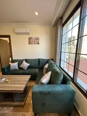 a living room with a couch and a table at 12 Antica jabalal-lwebdeh in Amman