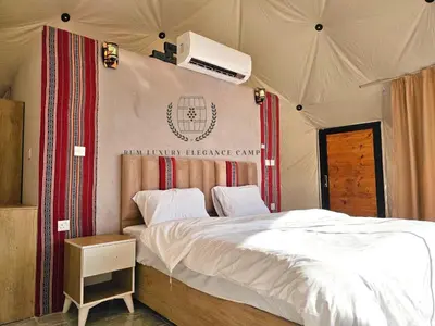 a bedroom with a bed in a tent at RUM lUXURY ELEGANCE CAMP in Wadi Rum