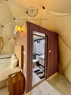 a room with a tent with a bed and a mirror at RUM lUXURY ELEGANCE CAMP in Wadi Rum