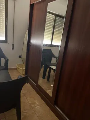 a wooden door with a mirror in a room at Samar Home in Amman